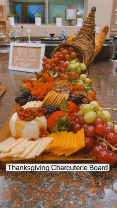 a table topped with lots of different types of cheeses and fruit on top of it