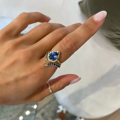 LOGAN HOLLOWELL ONLINE & IN-STORE EXCLUSIVE 18k gold and premium water drop blue sapphire in an elegant crown bezel setting with a full pavé white diamond halo totaling 0.25 carat weight. Logan Hollowell, Elegant Crown, Baby Queen, Layered Rings, Hand Chain, Aquamarine Blue, Diamond Halo, Water Drop, Halo Diamond