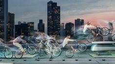 a group of people riding bikes in front of a city skyline