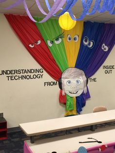 an office decorated with colorful dr seuss masks and paper streamers hanging from the ceiling