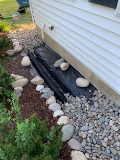 the rocks are laying on top of the black tarp to keep them out of the water