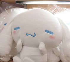 a white stuffed animal sitting on top of a table