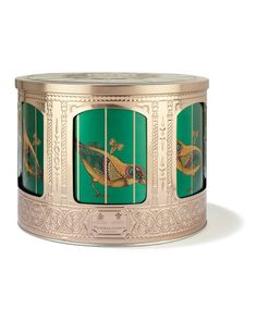 an ornately decorated tin canister with birds on the sides and green panels around it