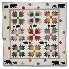 a quilted wall hanging with bears and maple leaves on the front, along with an image of a bear