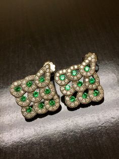 DeKara Designs Collection Metal- 14K Yellow Gold, .583 Stones- 18 Round Emeralds 1.00 Carats, 104 Diamonds F-G VS2 Clarity 1.10 Carats. Measurement- 0.83 Inches Long, 0.75 Inches Wide. Art Deco Influenced Beautifully Handmade 14K White Gold Diamond Emerald Drop Earrings. The earrings feature nine half bezel set beautiful fine Colombian round emeralds on each earring. The emeralds are surrounded by pear shaped settings that have pave set round diamonds all throughout. Each earring has a total of Luxury Green Bridal Earrings, Luxury Green Clip-on Earrings, Luxury Green Hand-set Earrings, Luxury Green Cubic Zirconia Earrings, Luxury Green Bridal Earrings As Gift, Luxury Green Bridal Earrings For Gift, Green Luxury Bridal Earrings For Gift, Diamond Emerald Earrings, Emerald Drop Earrings