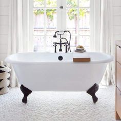 a white bath tub sitting next to a window