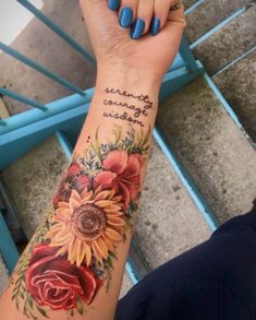 a woman's arm with sunflowers and roses on it