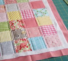 a patchwork quilt is being made on a cutting board