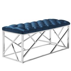 a bench made out of metal and blue velvet