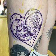 a couple of tattoos on the legs of someone's leg, one with a heart and two skulls