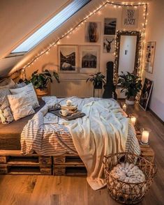 an attic bedroom is decorated with string lights and pictures on the wall above the bed