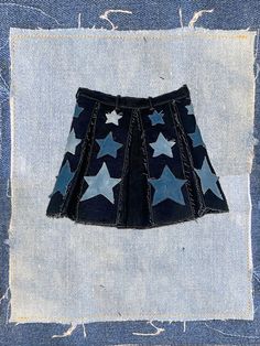 -made to order- 100% deep-navy denim with a hand-sewn/treated denim star design, perfect for the diva that knows 'these are my legs and they're ready for prime-time'. each 'box pleat' is framed with a distressed navy-blue patchwork and three distressed stars. this garment is built to fray and get even better after multiple wears. zipper in back with waistband snap. length: '14-'15 see FAQ for size chart all pieces sewn by me made-to-order items ship within 1-2 weeks. Denim Stars, The Diva, Prime Time, Star Design, Box Pleats, Womens Skirts, Star Designs, Star Shape, Pleated Skirt