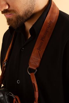 a man with a camera strap around his neck