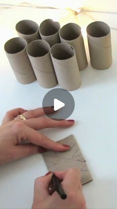 a person is doing crafts with toilet paper rolls