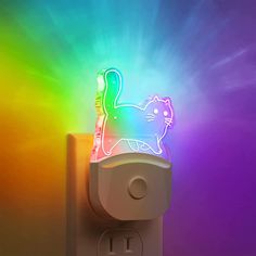 a colorful light that is on top of a electrical outlet with a cat figure in it