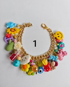 a close up of a bracelet with many different items on the chain and number one