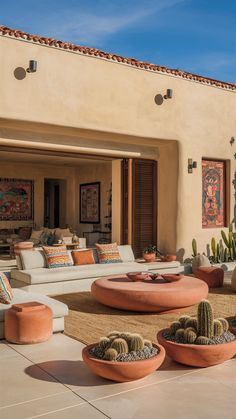 an outdoor living area with cactus plants and potted cacti