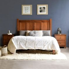 a bedroom with blue walls and white bedding