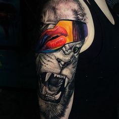 a person with a tattoo on their arm has a tiger and red lipstick painted on it