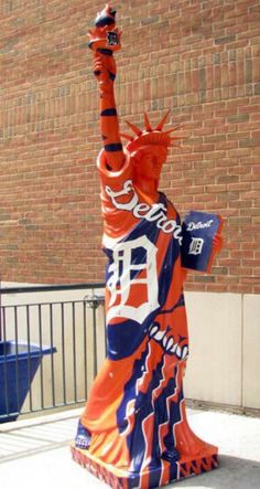 a statue of a baseball player with his hand up in the air