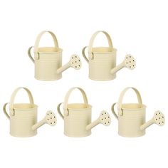 four white watering cans with handles and polka dots on them