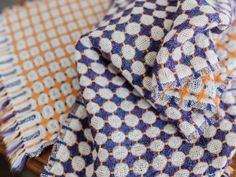 an orange and blue checkered cloth on a wooden table