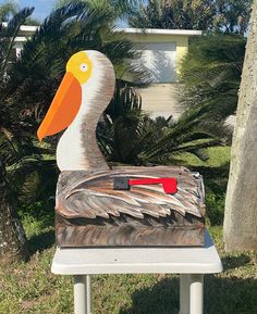 a wooden duck sitting on top of a white bench