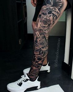 a man's leg with tattoos on it