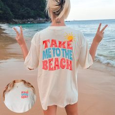 "Crafted from soft and breathable Comfort Colors fabric, this oversized t-shirt offers a relaxed fit and a lived-in feel. Its loose and casual design makes it ideal for beach outings, summer adventures, or simply lounging by the shore. Featuring graphics on both the front and back, this t-shirt proudly displays the phrase \"Take Me to the Beach\". The coastal-inspired design captures the essence of beach life and invokes a sense of relaxation and wanderlust. Whether you're planning a beach getaway, reminiscing about past beach vacations, or simply dreaming of the ocean, this t-shirt is the perfect companion. Its oversized style allows for easy layering or wearing on its own, making it a versatile addition to your summer wardrobe. Share your love for the beach and let your free-spirited nat Beach T Shirt Outfit, Beach Graphic Tee, Beach Shirt Ideas, Beach Tshirt Ideas, Summer Tshirt Designs, Take Me To The Beach, Beach Tshirt, Summer Tshirt, Tshirt Oversized