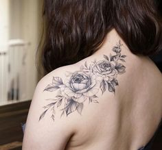 the back of a woman's shoulder with flowers on it