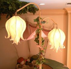 a lamp that is on top of a table in front of a potted plant