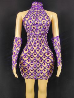 a mannequin with purple and gold sequins on it's body