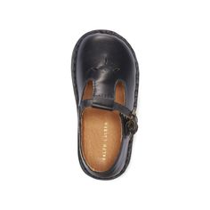 This classic shoe is crafted from smooth leather and designed with a T-strap silhouette. Classic Closed Toe Mary Janes With Buckle, Leather Mary Janes With Penny Strap And Round Toe, Classic Leather Mary Janes With Buckle Closure, Classic Leather Mary Janes With Penny Strap, Classic Mary Janes With Leather Sole, Classic Leather Closed Toe Mary Janes, Classic Leather T-strap Mary Janes, Classic Closed Toe Mary Janes With Rubber Sole, Leather Mary Janes With Stitched Sole