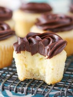 cupcakes with chocolate frosting sitting on a cooling rack