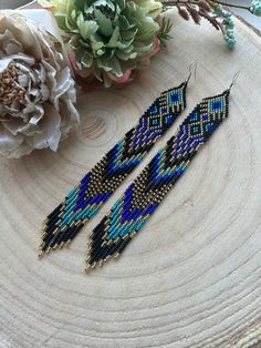 These long dangling earrings made of blue beads with gold accents and fringe perfectly combine sophistication and style. Made from Czech beads. Length 7.2 inches (18cm) Width 0.8 inches (2 cm) Hypoallergenic clasp If you want these earrings in a different color, write to me and I will be happy to make them for you. Blue Fringe Dangle Chandelier Earrings, Blue Tassel Earrings With Round Beads, Blue Beaded Fringe Dangle Jewelry, Blue Dangle Earrings With Latkans, Blue Fringe Beaded Drop Earrings, Blue Fringed Beaded Drop Earrings, Blue Dangle Chandelier Earrings With Latkans, Blue Long Drop Jewelry With Beaded Fringe, Blue Chandelier Dangle Earrings With Latkans