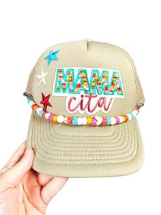 Mamacita needs this hat! Our tan trucker hat with embroidered patches makes a great gift for mom for Mother's  day or anytime of the year. The colors are gorgeous on this one! This stunner comes with the brim chain of choice. Be sure to pick your favorite in the drop down menu.  *if you would like something custom, please reach out BEFORE ordering a hat. We have 100's of patches and can accommodate most any request.  No refunds or exchanges but we still love ya babe and will gladly help if a sit Trucker Baseball Cap With Flat Brim For Gift, Personalized Brown Hat As A Gift, Trucker Hat With Flat Brim As Gift, Flat Brim Trucker Hat As Gift, Custom Personalized Adjustable Hats, Flat Brim Trucker Hat For Gifts, Custom Trucker Hat With Curved Brim As Gift, Customized Adjustable Snapback Hat, Custom Snapback Trucker Hat As Gift