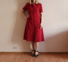 "Vintage Dress Red Women Dress Short Sleeve Dress Red Button up Secretary Dress A-Line Polyester Dress Lined Shoulder Pads Shown on model M/L Measurements: (lying flat) Shoulder: 15\"/ 38 cm Sleeve: 9.5\"/ 24 cm Bust: 18.5\"/ 47 cm Waist: 16.5\"/ 42 cm Length: 44\"/ 112 cm Please check measurements to insure a proper fit. Remember to allow yourself some extra room for movement. You can compare these with something from your closet that fits you well Condition: great Vintage Condition N.B. Color may slightly differ from picture. SHIPPING * I ship worldwide via Priority mail * Items are shipped 3 - 5 business days after receiving the payment. * I ship from Europe, so please allow 2 to 3 weeks for the package to arrive if you live overseas. * Europe 5 - 10 business days. BK 2" Red A-line Midi Dress With Buttons, Fitted Red Shirt Dress For Summer, Red Midi Dress With Button Closure, Red Buttoned Shirt Dress For Summer, Red Short Sleeve Midi Dress For Daywear, Red Workwear Dresses With Button Closure, Fitted Red Dress With Buttons, Fitted Red Dresses With Buttons, Red Button-up Shirt Dress For Work