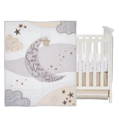 a white crib bed with a baby's name on the moon and stars