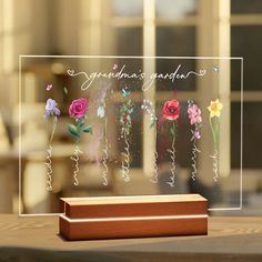 a clear acrylic sign with flowers on it