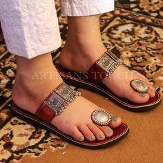 Handcrafted Leather Ethnic Slipper with Silver Toe Ring Detailing - Women's Silver Toe Ring Slippers  Description:  Step into a world of timeless elegance and comfort with our exquisite Handcrafted Leather Ethnic Slipper adorned with silver toe ring detailing, exclusively designed for women who appreciate style and tradition. These meticulously crafted slippers are the perfect blend of fashion, culture, and comfort, making them an essential addition to your footwear collection.  🌟 Key Features:  ✨ Handcrafted Excellence: Our skilled artisans put their heart and soul into creating each pair of these leather ethnic slippers. The result is a masterpiece of craftsmanship, featuring intricate detailing that reflects the rich heritage of traditional footwear.  ✨ Silver Toe Ring: The highlight o Bohemian Toe Ring Sandals As Gift, Traditional Toe Loop Barefoot Sandals For Festival, Bohemian Silver Open Toe Sandals, Silver Bohemian Open Toe Sandals, Traditional Hand-tooled Brown Sandals, Traditional Brown Hand-tooled Sandals, Traditional Leather Toe Ring Sandals For Festivals, Traditional Brown Toe Ring Sandals For Festival, Traditional Adjustable Toe Post Sandals