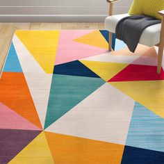 a brightly colored rug with a chair in the background