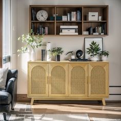 a living room with a couch, chair and bookshelf on the wall above it