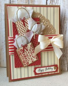 a close up of a birthday card on a wooden table with white and red decorations