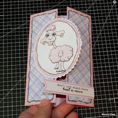 someone holding up a card with a sheep on it