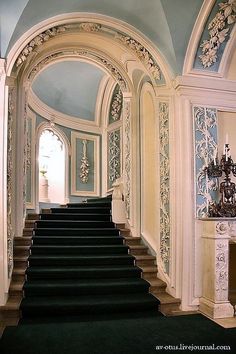 a staircase leading up to an ornately decorated room