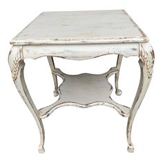 an old white wooden table with ornate carvings on the top and bottom, isolated against a white background