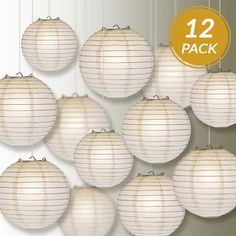 many white paper lanterns hanging from strings with the number 20 on each one in front of them