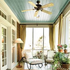 a living room filled with furniture and a ceiling fan