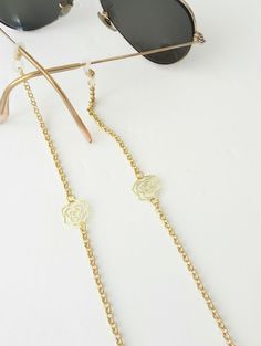 Sunglasses gold chain,  Eyeglass necklace, Flowers sunglasses chain, Dainty reading glasses gold chain, Trendy Chain, Eyewear Holder Chain Beautiful fashion trend sunglasses gold plated aluminum chain decorated with gold plated flowers Lightweight gold chain with rubber ends Total length is 70cm / 27.7 inches. Beautifully packaged and ready for gift giving.  JEWELRY CARE: Please take care of your jewelry do not wear in the shower, swimming pool, or to bed.  Keep away from harsh chemicals and cle Trendy Gold Glasses Chain For Gift, Trendy Gold Glasses Chains As Gift, Gold Chain Necklace As Summer Gift, Gold Chain Necklace For Summer, Trendy Gold Chain Glasses Chains As Gift, Gold Chain Necklace Summer Gift, Trendy Gold Chain Glasses Chain For Gift, Elegant Metal Glasses Chains For Summer, Chic Adjustable Glasses Chain As Gift