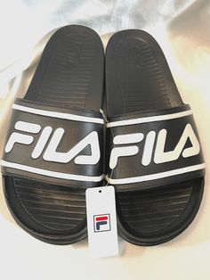 FIla Mens Sandals Item Details Fila Sleek Slide Sandals Mens Size: 12 Colors: Black with White Material: Synthetic upper Durable traction outsole Contoured footbed 100% Authentic. Brand New with Tags Featured Items Check Out other FILA items in the Real Deal Addict Brand Name Outlet   Trusted Seller - Buy with Confidence At Real Deal Addict Brand Name Outlet, all of our merchandise is 100% Authentic.  If you have a question or a concern, please contact us first. If something is in our error, we Fila Slides, Mens Shoes Sandals, Sandal Fashion, Mens Sandals, White Material, Slide Sandals, Slides, Shoes Sandals, Outlet